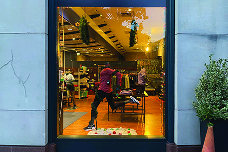 window display with a running mannequin and holiday decorations