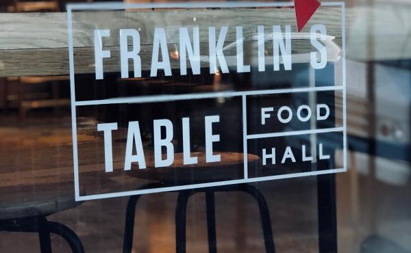 signage in window at Franklins Table