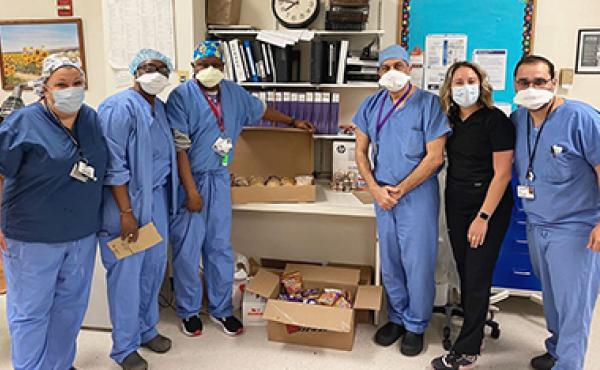 medical professionals posing with donated food