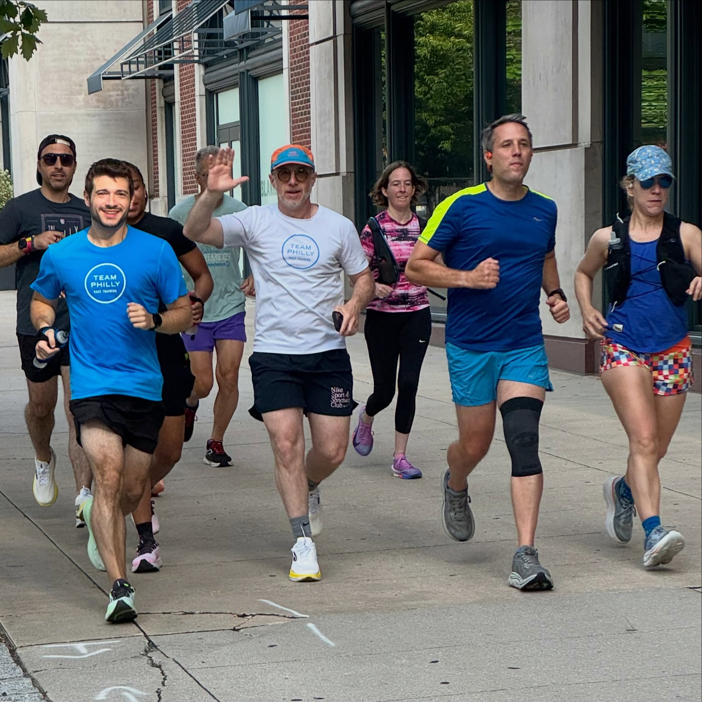 people running on a sidewalk