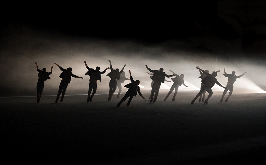 ice skaters performing in shadow