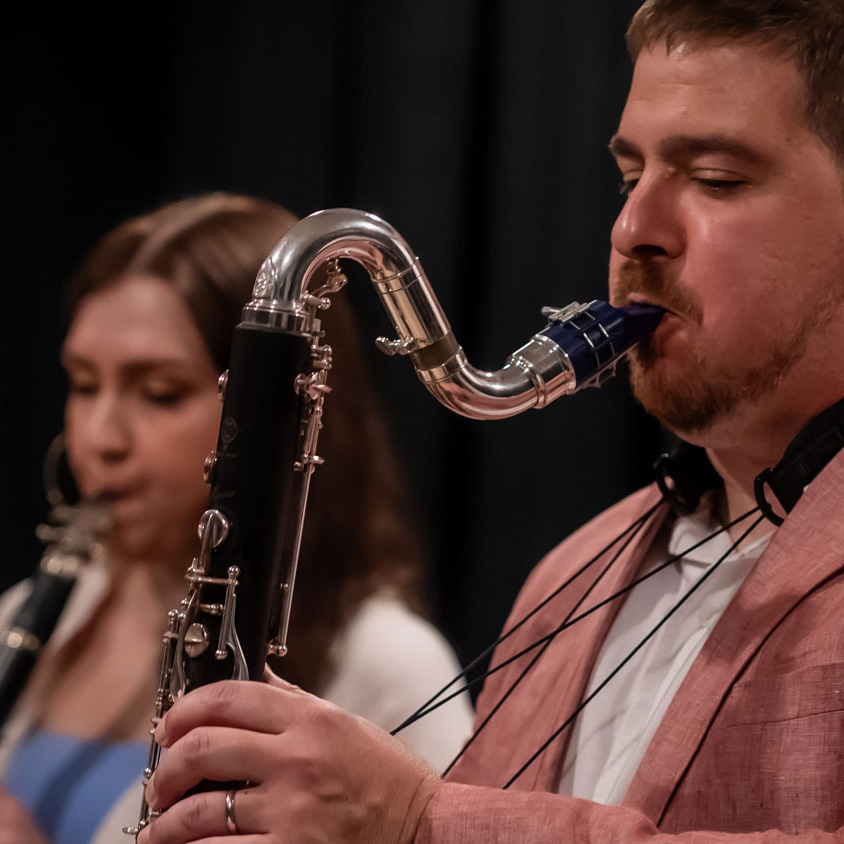 man playing a sax and woman playing a clarinet