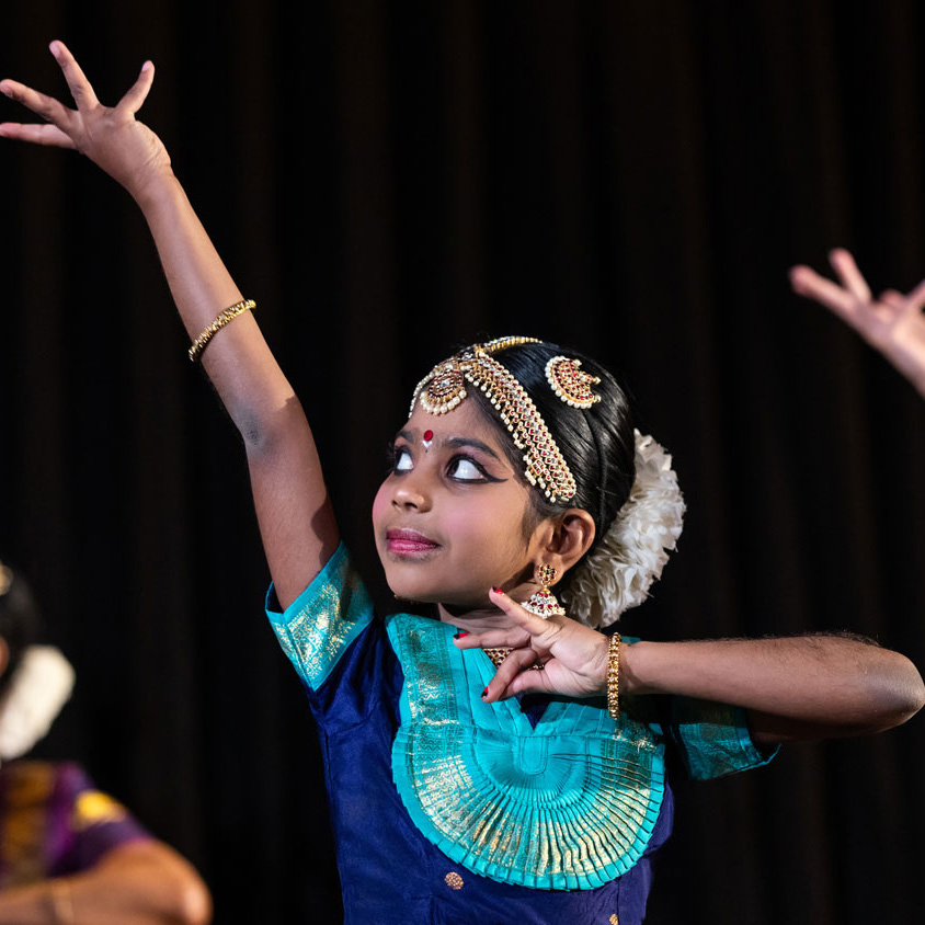 young indian girl performing holi dance