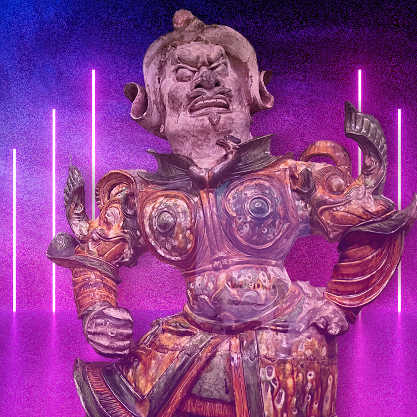 asian sculpture in front of neon lights