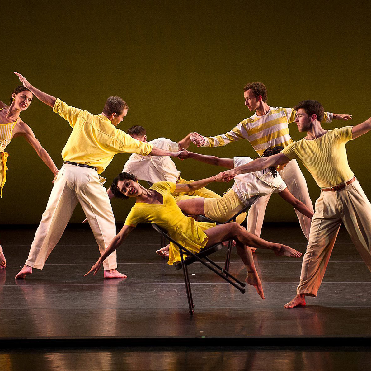 September Playlist Front dancers performing in yellow outfits on a stage