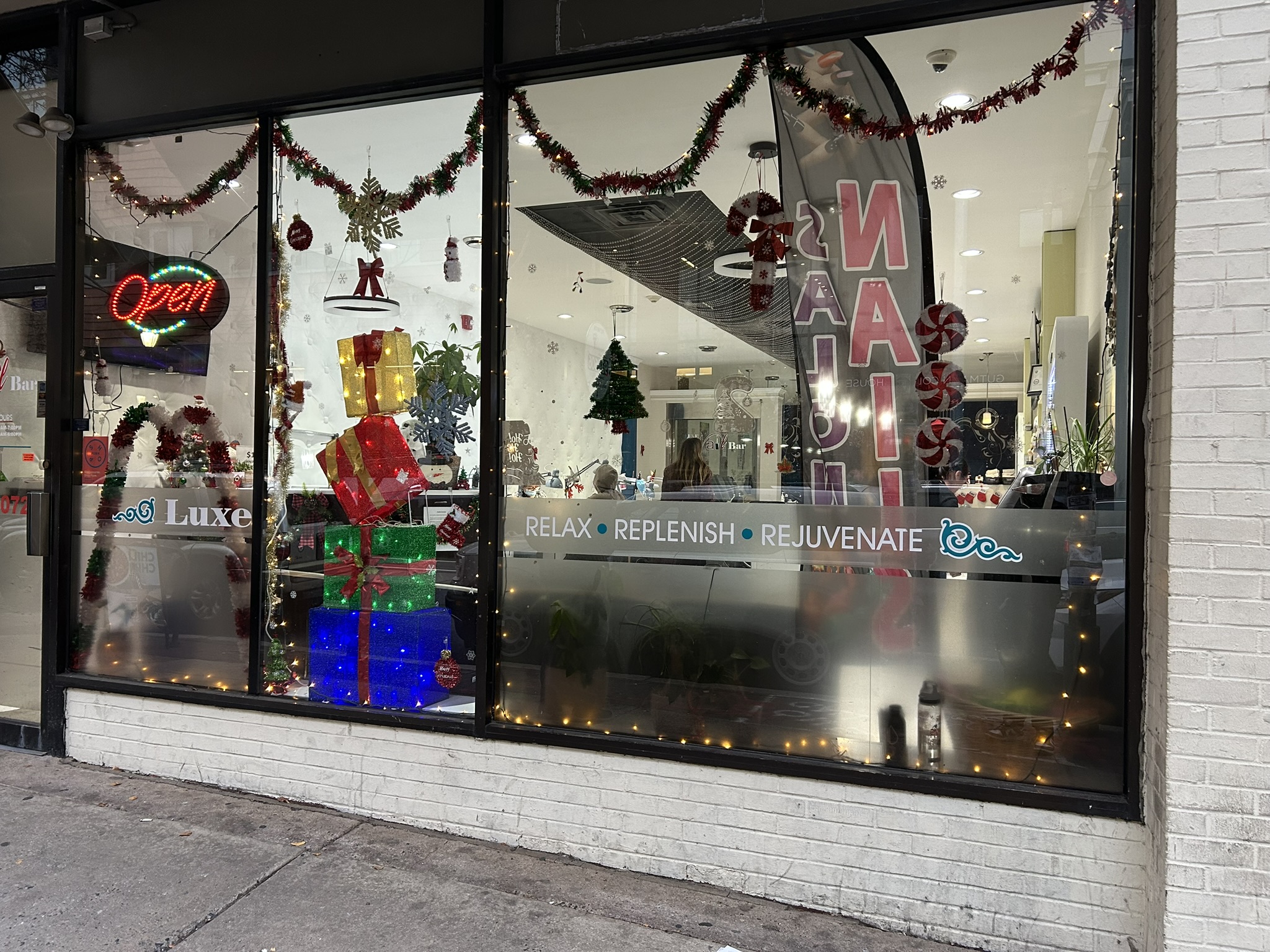 nail salon window decorated for holidays