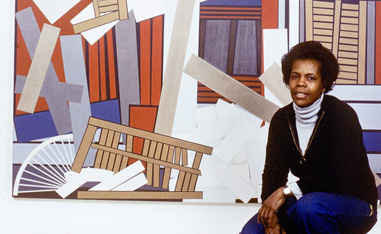 africn american woman squating and posing in front of a piece of art