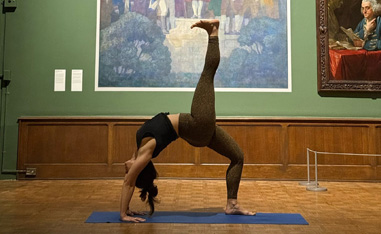 woman doing yoga in an art gallery