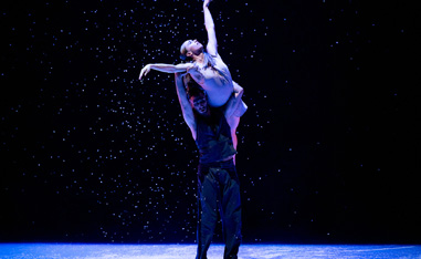 male and female ballet performers performing on stage, male lifting woman