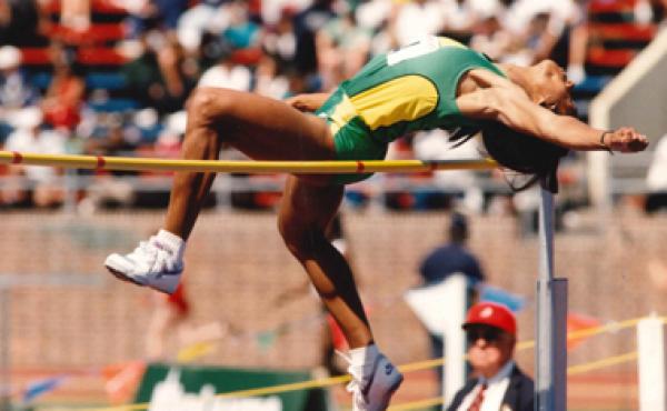 woman clearing bar in high jump