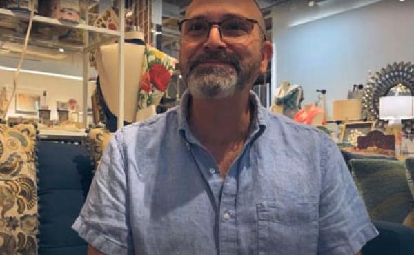 bearded man sitting in a shop