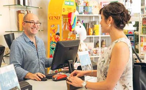 smiling man talking to woman in shop