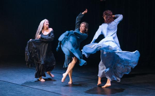 three ladies in dresses dancing