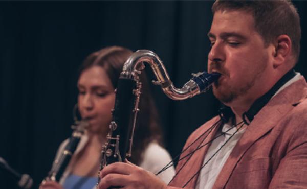 man and woman playing a sax and clarinet