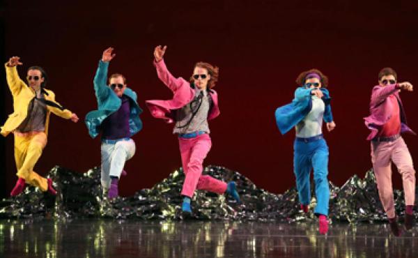 men in colorful suits and sunglasses dancing