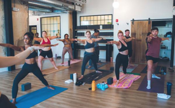 people participating in an indoor yoga class