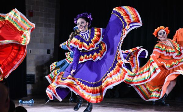 dia de los muertos dancers in makeup and costumes performing