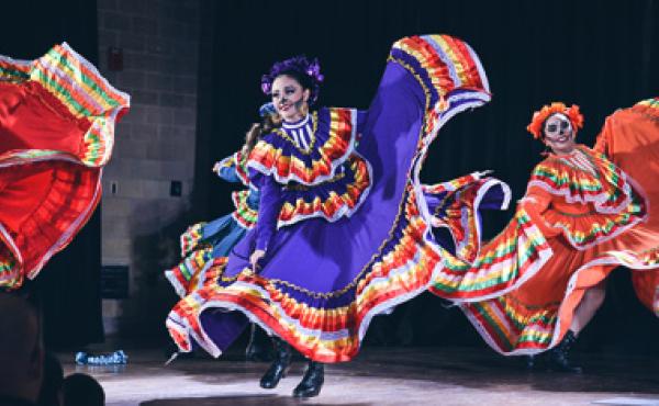 dia de los muertos dancers in makeup and costumes performing