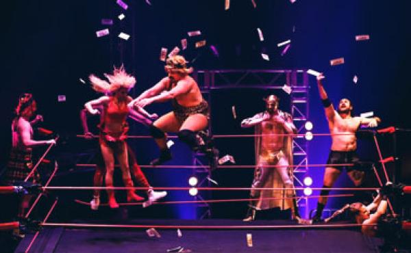 performers on stage in a wrestling ring