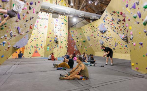 wide shot of climbing gym with people in it
