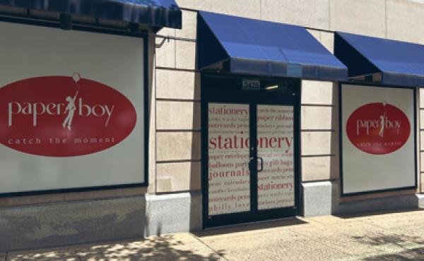 Storefront with doors and windows wrapped in paperboy brandings