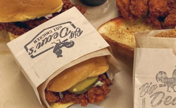 fried chicken sandwich in a paper wrapper with big dean's logo