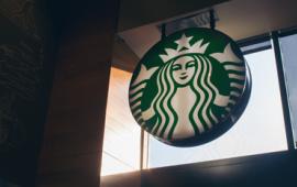 Starbucks logo sign inside a Starbucks cafe.
