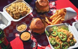 selection of burgers and fries laid out on display on a table