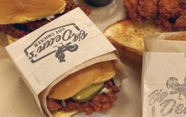 fried chicken sandwich in a paper wrapper with big dean's logo