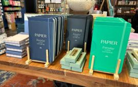 notebooks and planners on display on a table
